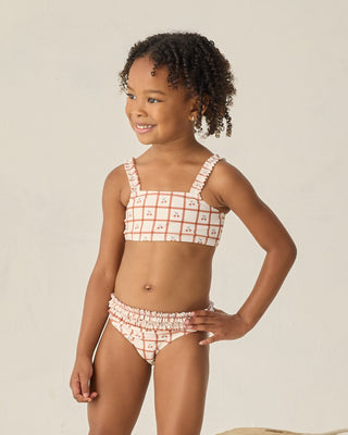 Rylee & Cru Rouched Bikini - Cherry Check
Young girl wearing a checkered bikini against a plain background