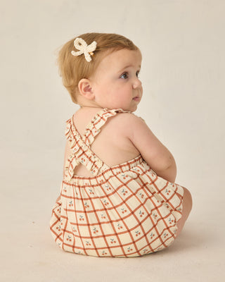 Rylee & Cru Chiara Romper - Cherry Check
Baby wearing a checkered dress with a bow in hair on a plain background