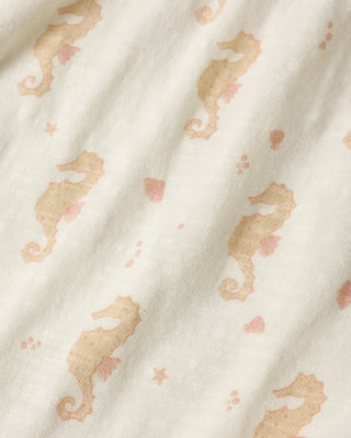 Rylee & Cru Nala Seahorses romper for toddlers, ivory-colored fabric with playful seahorse print, soft and comfortable for warm weather.