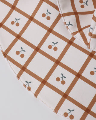 Rylee & Cru Floppy Swim Hat - Cherry Check
Fabric with brown checkered pattern and cherry illustrations on a white background