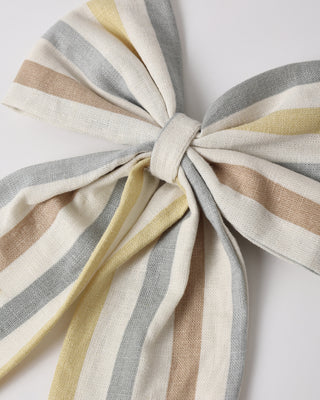 Rylee & Cru Valencia Stripe oversized bow hair accessory in natural fabric, styled on a flat surface with a bow shape.