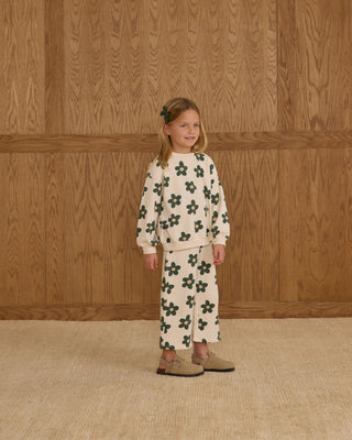Rylee & Cru Oversized Sweatshirt & Wide Leg Sweatpant Set - Daisy
Young girl wearing a floral outfit standing against a wooden paneled wall.