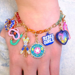 Charm It! Gold Rebel Girls Space Shaker Charm
Colorful charm bracelet on a wrist with 'REBEL GIRLS' and other decorative charms.