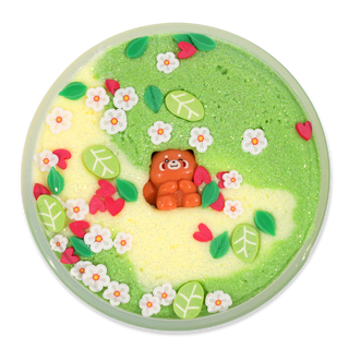 Peachybbies Cloud Slime - Red Panda Forest
A round green and pale yellow dessert or candy dish decorated with white flowers, green leaves, red hearts, and a small orange bear figure in the center, shown on a plain white background.