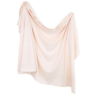 Lou Lou and Company Ribbed Swaddle Blanket in Rosie color, soft and cozy for newborns, with textured ribbed fabric.