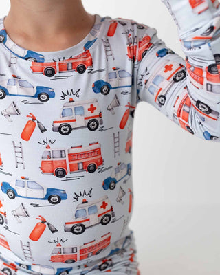 Lev Baby Pajama Set - Ryan
Children's outfit with emergency vehicle pattern on a white background