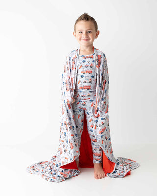 Lev Baby Pajama Set - Ryan
Child wearing a patterned robe with a hood on a white background