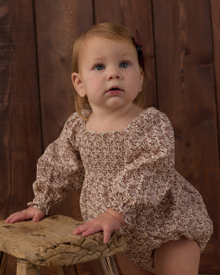 Rylee & Cru Adelaide Romper - Primrose
Baby in a floral outfit sitting on a wooden stool against a wooden background