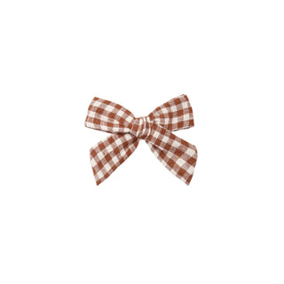 Rylee & Cru Bow - Brick Check
A small fabric bow with a brown and white gingham check pattern, centered on a plain white background.
