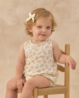 Rylee & Cru Bubble Romper - Yellow Ditsy
Young child sitting on a chair wearing a floral dress against a beige background