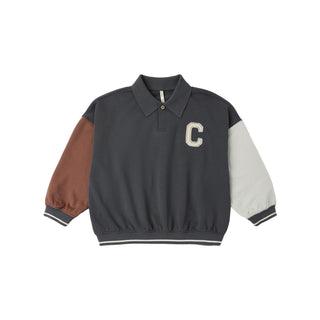 Rylee & Cru Collared Sweatshirt - Color Block
A color-blocked long-sleeve polo jacket with a dark gray body, brown left sleeve, and off-white right sleeve, featuring a large cream letter 'C' on the chest and striped ribbed cuffs and hem.