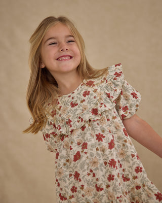 Rylee & Cru Cordelia Dress - Holiday Floral
Young girl wearing a floral dress against a beige background