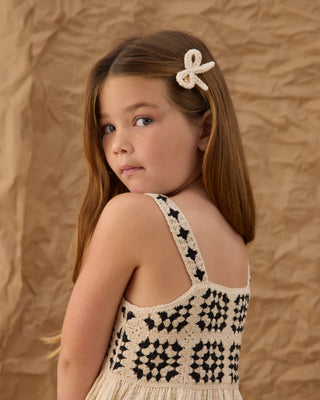 Rylee & Cru crochet sundress in abstract pattern, lightweight dress for girls, displayed on a hanger with a soft background.