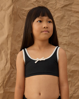 Black Rylee & Cru Daisy Bikini swimsuit with floral pattern, featuring adjustable straps and a comfortable fit.