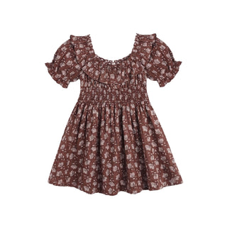 Rylee & Cru Dillon Dress - Mulberry Iris
A toddler girl's dress in a brown and beige floral pattern, featuring a smocked bodice, ruffled off-the-shoulder sleeves, and a flared skirt, shown against a plain white background.