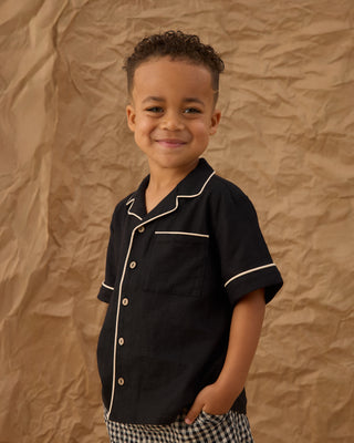 Black Rylee & Cru lapel collared shirt displayed flat with button details and tailored fit, perfect for casual or semi-formal wear.