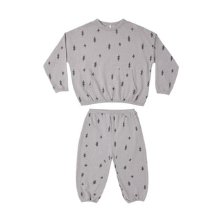 Rylee & Cru Relaxed Set - Bolts
A two-piece children's loungewear set in light gray, featuring a long-sleeve top and matching pants, both printed with a small black tree motif.