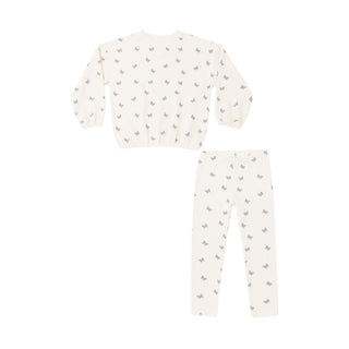 Rylee & Cru Spongy Knit Set - Butterfly Ditsy
A two-piece children's pajama set featuring a long-sleeve top and matching pants in a warm off-white/cream color, both printed with a small repeating gray pattern of birds or butterflies.