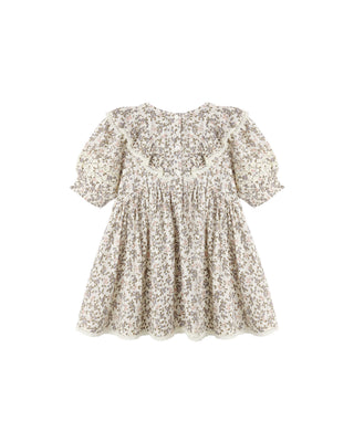 Rylee & Cru Winnie Dress - Winter Garden
A short-sleeve baby dress with a dense beige and brown floral print, featuring puff sleeves, a ruffled neckline, and a gathered skirt, shown against a plain white background.