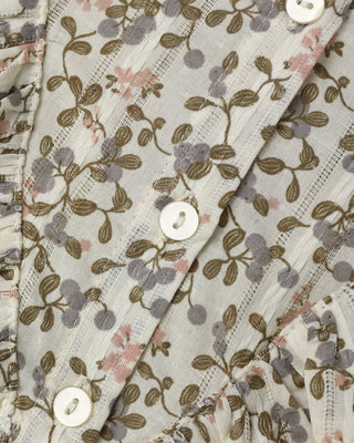 Rylee & Cru Winnie Dress - Winter Garden
Close-up of a lightweight fabric garment with a floral vine print in olive green, dusty purple, and soft pink on a warm off-white background, featuring white buttons.
