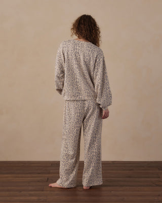 Rylee & Cru Women's Oversized Sweatshirt - Blue Leopard
A person standing with their back to the camera wearing a matching two-piece pajama set with a beige and brown animal print pattern, set against a neutral beige wall and dark wood floor.