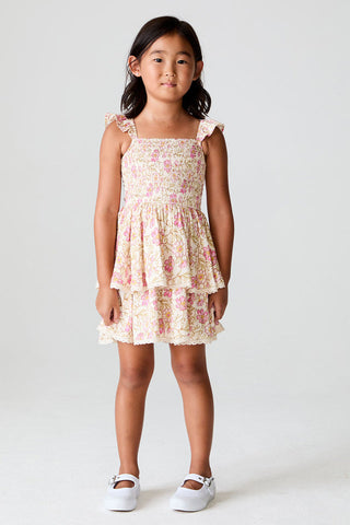 Saltwater Littles Raynbow Mini Dress in Ivory
Young girl wearing a floral dress against a plain background