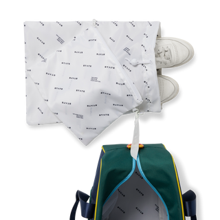 Navy State Bags Rockaway Duffle Bag with Dino Fossils print, designed for kids, featuring a spacious and durable duffle style.