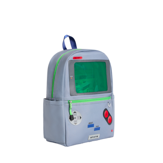 State Bags Kane Backpack - Vidoegame
A light gray backpack designed to look like a retro video game console, featuring a green screen window, red buttons, and a blue handle, shown on a plain white background.