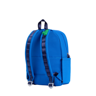 State Bags Kane Backpack - Digital Puzzle
A bright blue backpack shown from the back on a clean white background, featuring dark navy shoulder straps, a top carry handle, and a small green accent tab near the top center.
