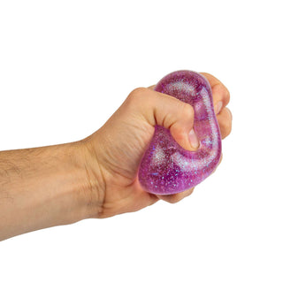 NeeDoh Glitter & Glow Nice Cube
Hand holding a purple glittery stress ball against a white background
