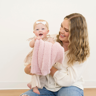 Saranoni Bamboni® Receiving Blanket - Light Pink
Woman holding a baby and a pink blanket against a white background