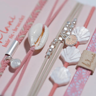 K'lani "Shimmer" Coral with Shell Hair Tie Bracelets
Set of hair accessories with shell and bead designs on a pink background