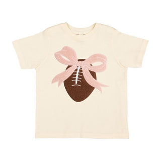 Sweet Wink Coquette Football Patch Short Sleeve T-Shirt - Natural Beige t-shirt with a football and pink bow design on a white background