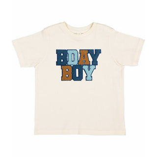 Sweet Wink Birthday Boy Patch Short Sleeve T-Shirt - Natural 
Beige t-shirt with 'BDAY BOY' text in blue, brown, and teal on a white background