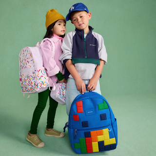 State Bags Kane Backpack - Digital Puzzle
Two children with colorful backpacks on a green background