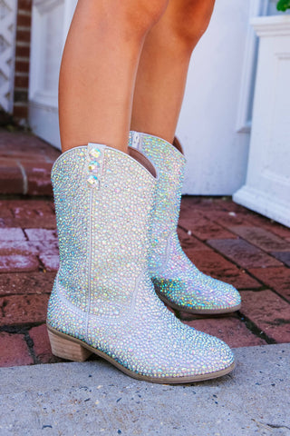 Lola and The Boys Silver Crystal Cowgirl Boots
Sparkly rain boots on a person standing on a brick pavement.