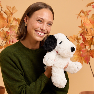 Snoopy Warmies
Woman holding a stuffed dog toy with a neutral background