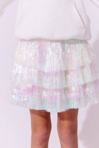 Lola and The Boys Snow Shimmer Tinsel Party Skirt
Iridescent tinsel skirt worn over a white top on a light pink background