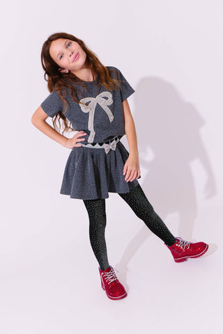 Lola and The Boys Sparkle Bow Charm Skirt Set Young girl wearing a gray dress with a bow design, black tights, and red shoes on a white background