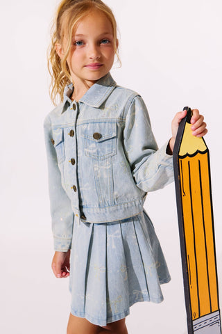 Lola and The Boys Sparkle Bows Denim Jacket
Young girl in a denim outfit holding a large pencil-shaped object on a white background