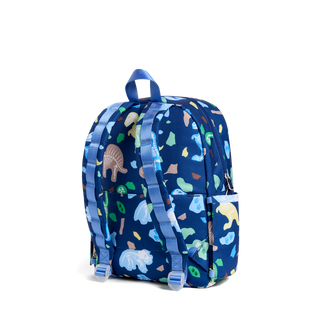 State Bags Kane Backpack - Dino Fossils
A navy blue backpack with a colorful dinosaur and leaf pattern, featuring light blue straps and a top carry handle, shown against a plain white background.