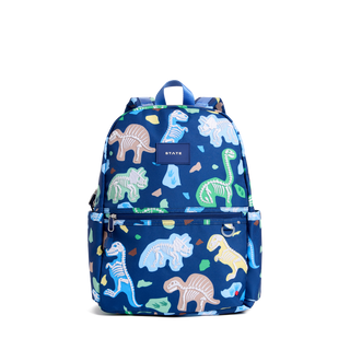 State Bags Kane Backpack - Dino Fossils
A blue backpack with an all-over dinosaur skeleton print in various pastel colors, featuring a top handle, side pockets, and a small 'STATE' brand patch on the front.