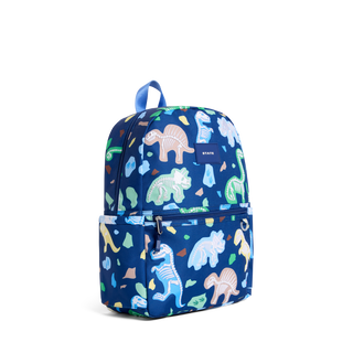 State Bags Kane Backpack - Dino Fossils 
A navy blue backpack with a colorful dinosaur skeleton pattern, featuring a top handle, a main zippered compartment, and a front zippered pocket. The brand name 'KAVU' is visible on a small dark blue label on the upper right side.
