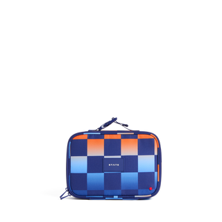 State Bags Rodgers Lunch Box -  Gradient Checkerboard
A rectangular zippered lunch bag with a blue, orange, and white checkerboard pattern, featuring a top carry handle and a small white 'STATE' logo on the front.