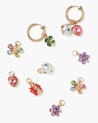 Super Smalls Absolutely Charming Clip On Earring Set 
Collection of colorful keychain charms on a white background