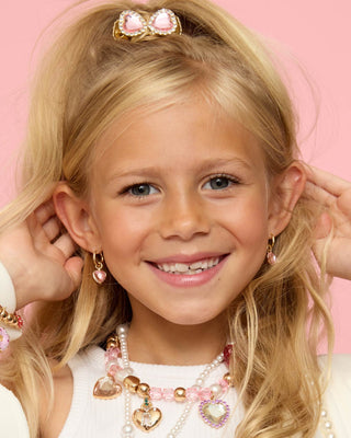 Super Smalls Absolutely Charming Clip On Earring Set
Young girl with blonde hair and accessories on a pink background