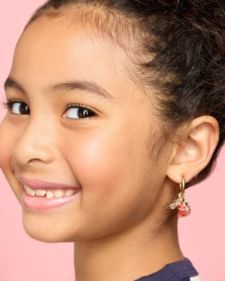 Super Smalls Absolutely Charming Clip On Earring Set
Close-up of a young girl wearing a colorful earring against a pink background