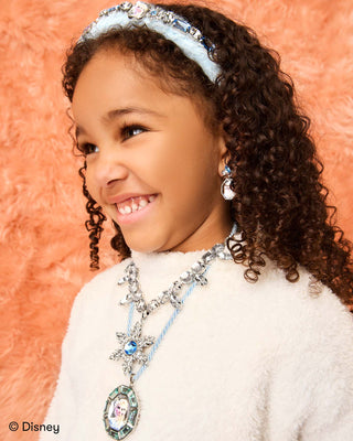 Super Smalls Disney Frozen Earring Set
Young girl wearing a decorative headband and necklace against an orange background