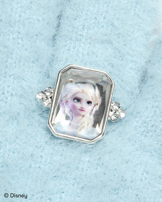 Super Smalls Disney Frozen Elsa Winter Jeweled Gloves
Ring with a portrait of a character in a silver frame on a light blue textured background.