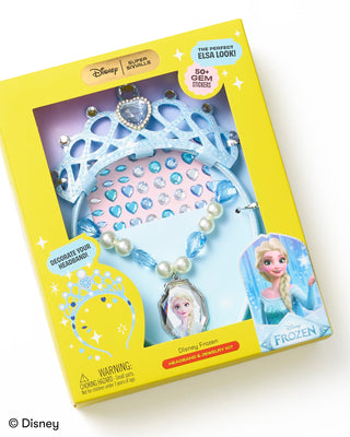 Super Smalls Disney Frozen Headband & Jewelry Kit
Disney Frozen Super Swirls toy set in its original yellow packaging box, featuring a light blue tiara, a pink gem-studded headband, and a blue and white beaded necklace with an Elsa portrait charm.